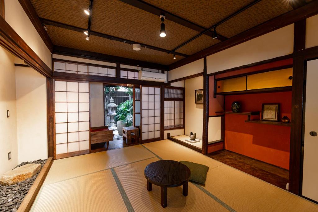 a room with a table and a stool in it at B&B Hachi in Kyoto