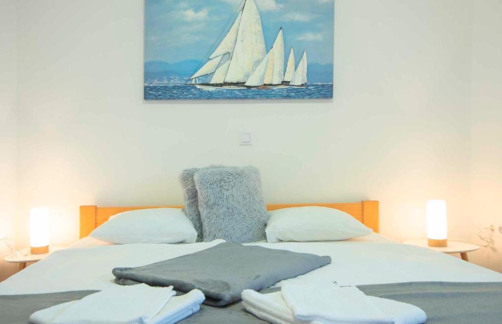 a bedroom with a bed with two white sails on it at Apartment Nina in Slunj