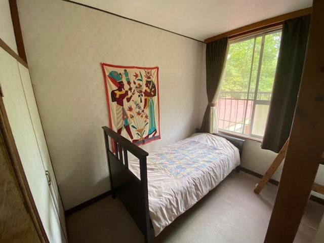 Postel nebo postele na pokoji v ubytování Guesthouse Oomiya base 大宮基地別荘