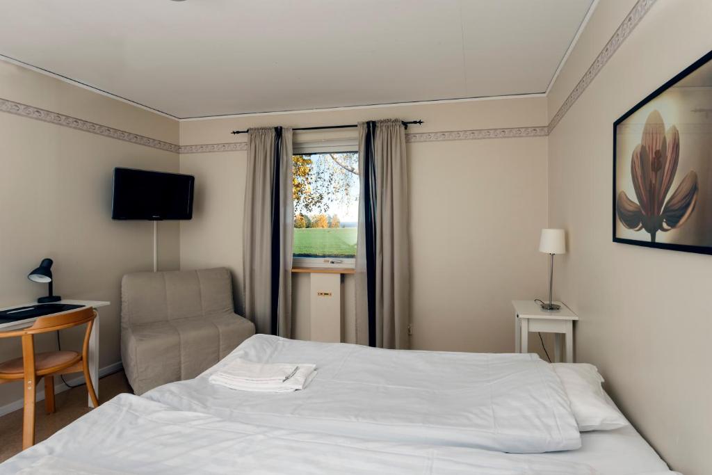 Postel nebo postele na pokoji v ubytování Wisingsö Hotell