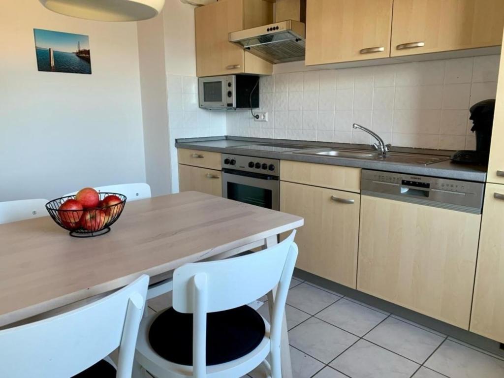 a kitchen with a table with a bowl of fruit on it at Haus Delbar in Bodman-Ludwigshafen