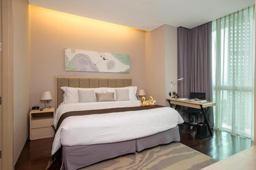 Postel nebo postele na pokoji v ubytování Fraser Residence Menteng Jakarta