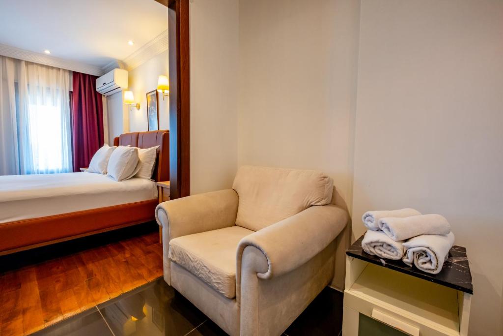 A bed or beds in a room at Mangana Konak Hotel