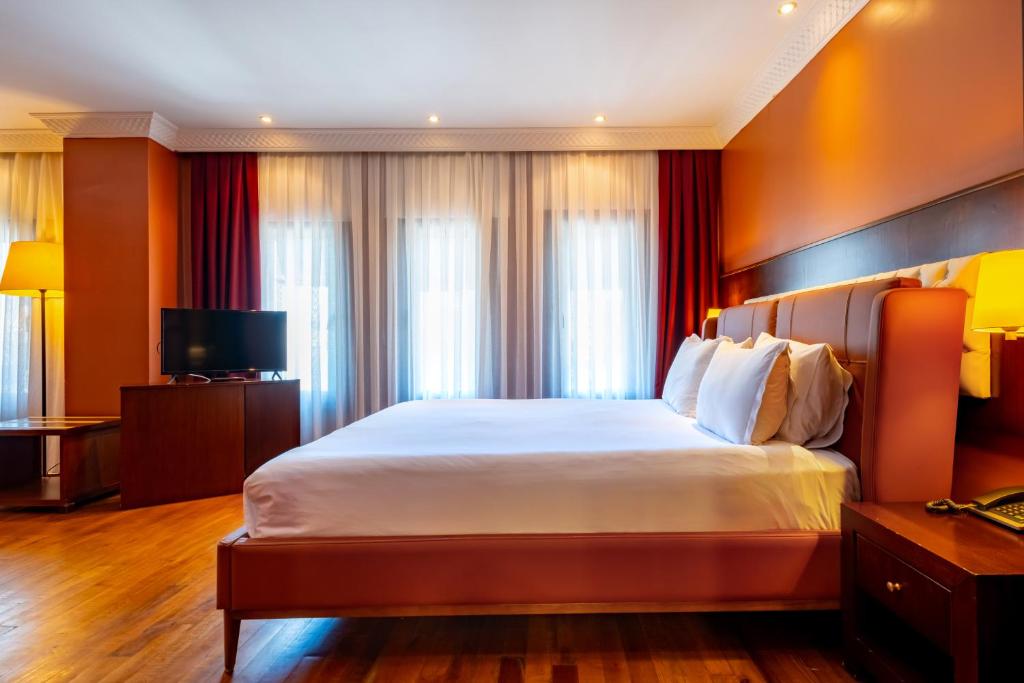 A bed or beds in a room at Mangana Konak Hotel