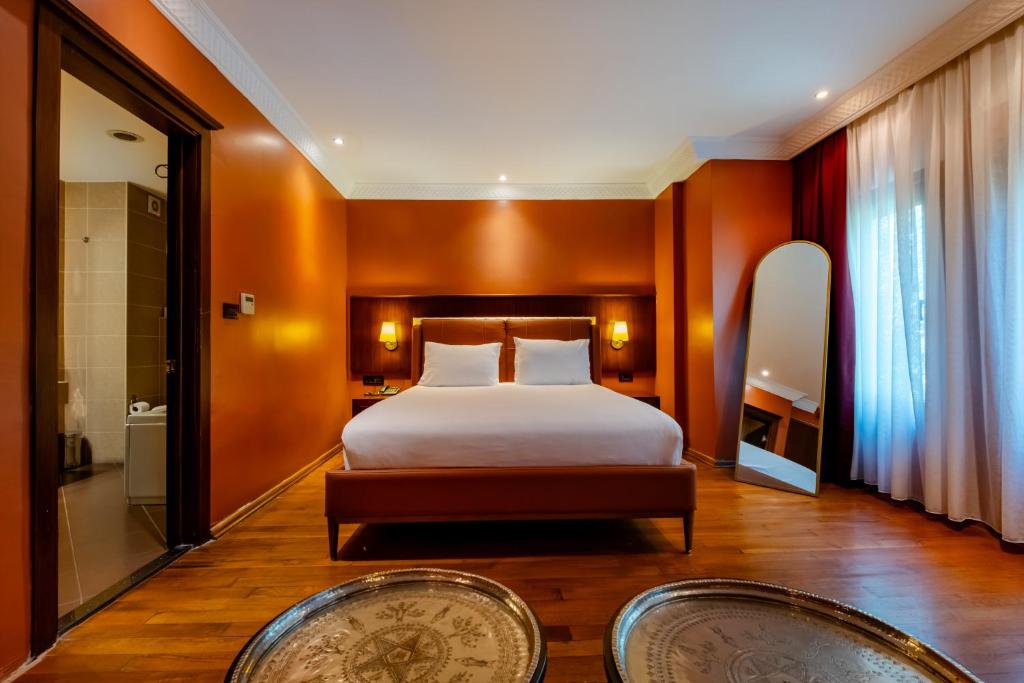 A bed or beds in a room at Mangana Konak Hotel
