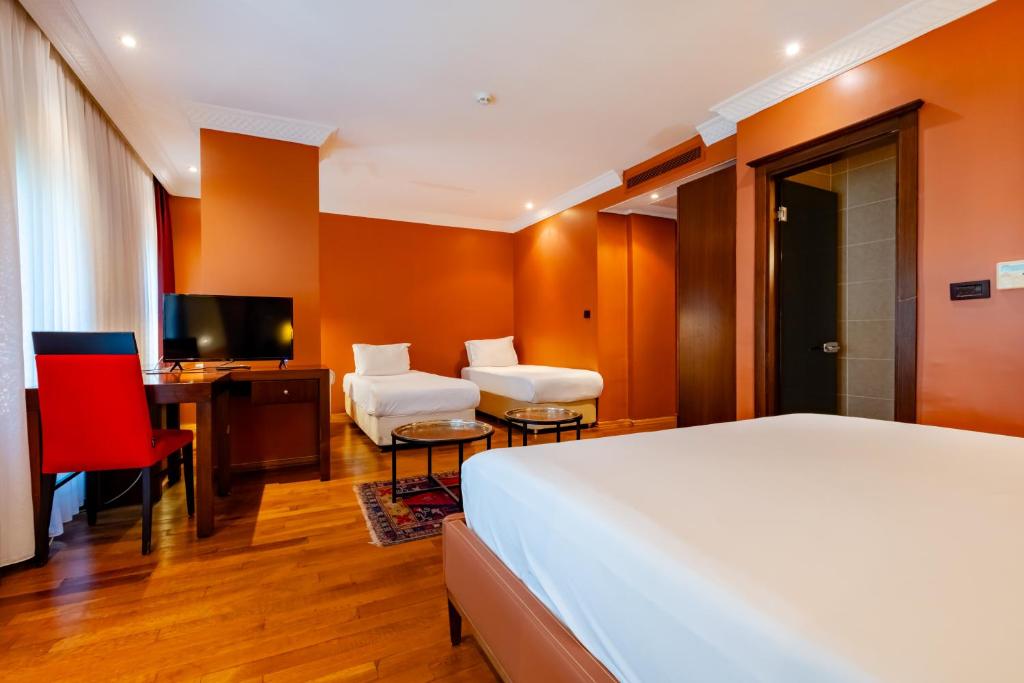 A bed or beds in a room at Mangana Konak Hotel