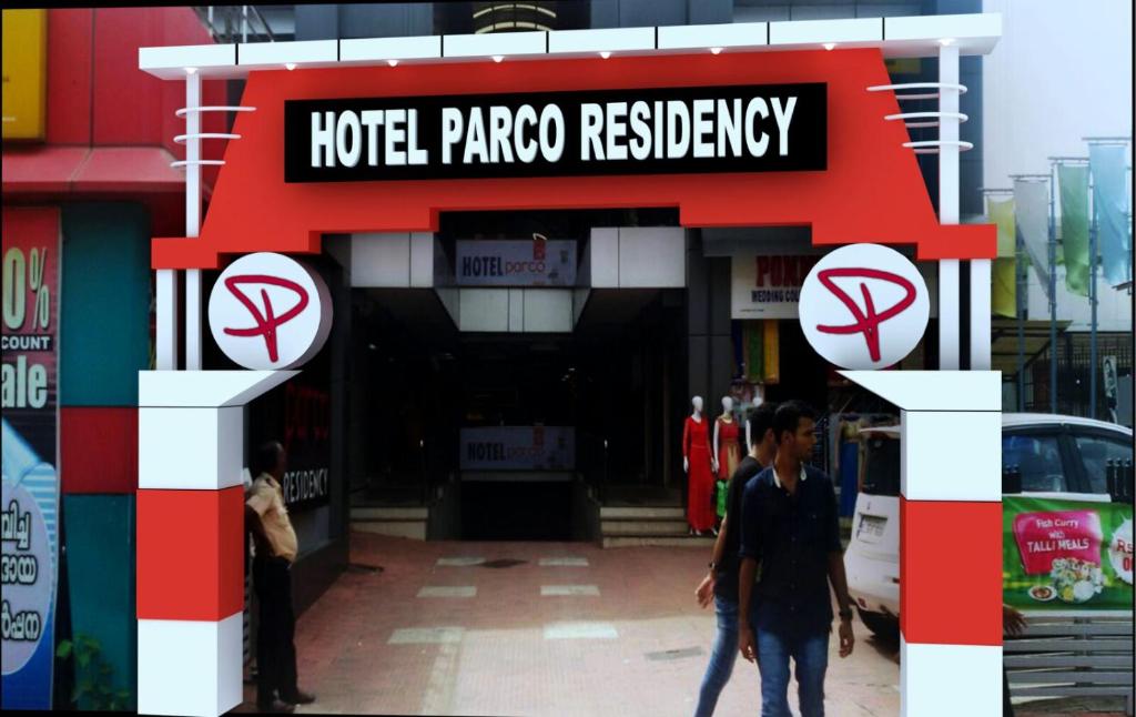 a sign for a hotel panchoresery in front of a building at Parco Residency in Tellicherry