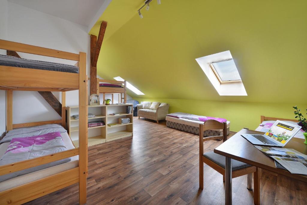 a room with two bunk beds and a table at Hostel Hluboká in Hluboká nad Vltavou