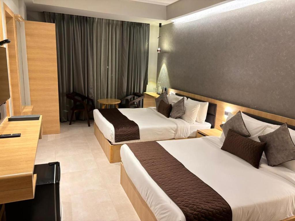 Postel nebo postele na pokoji v ubytování Northin Hotel