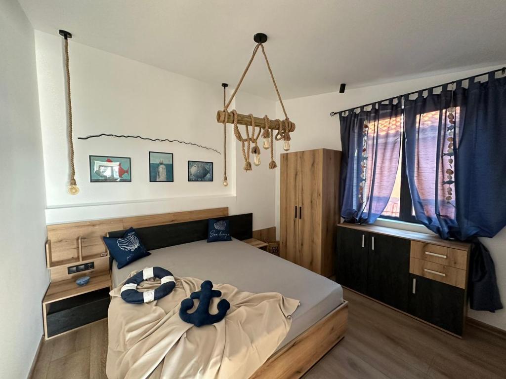 a bedroom with a large bed with blue pillows on it at Alta Vista Apollonia in Sozopol