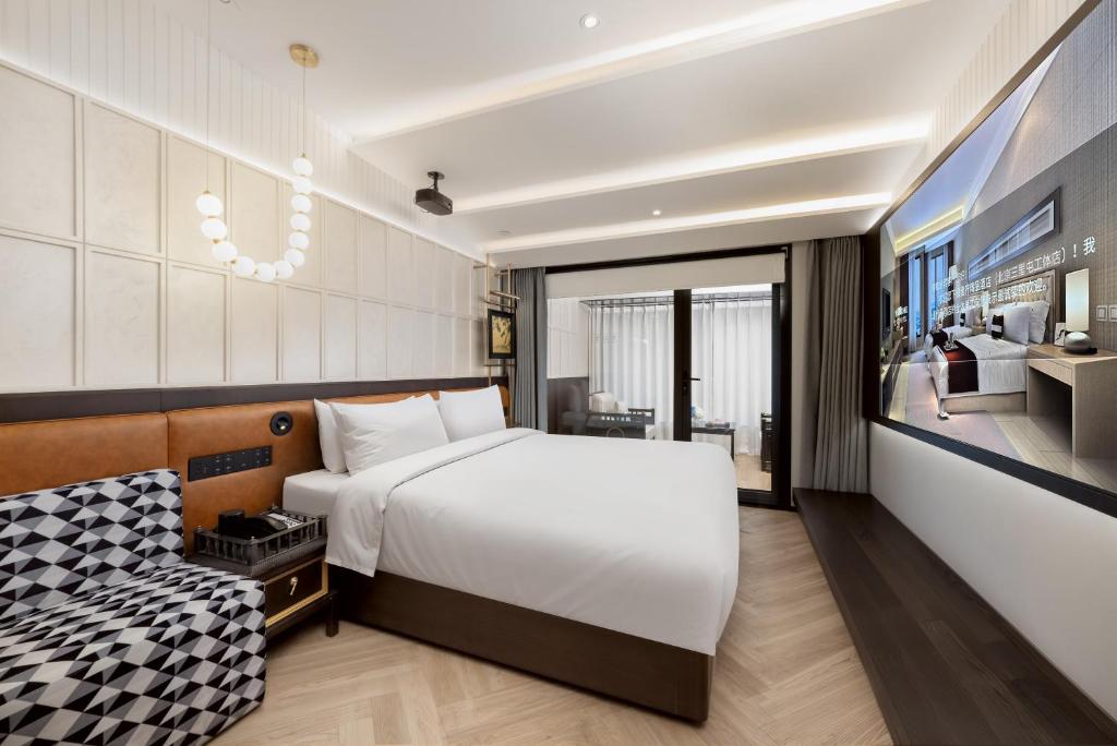 Postel nebo postele na pokoji v ubytování Beijing Tangfu Sanlitun BOUTIQUE Hotel---Breakfast, restaurant and bar, close to Tian'anmen Square Forbidden City Temple of Heaven, laundry, gym, robot, ticket service, located in city center Metro line 2, one station to Airport Express