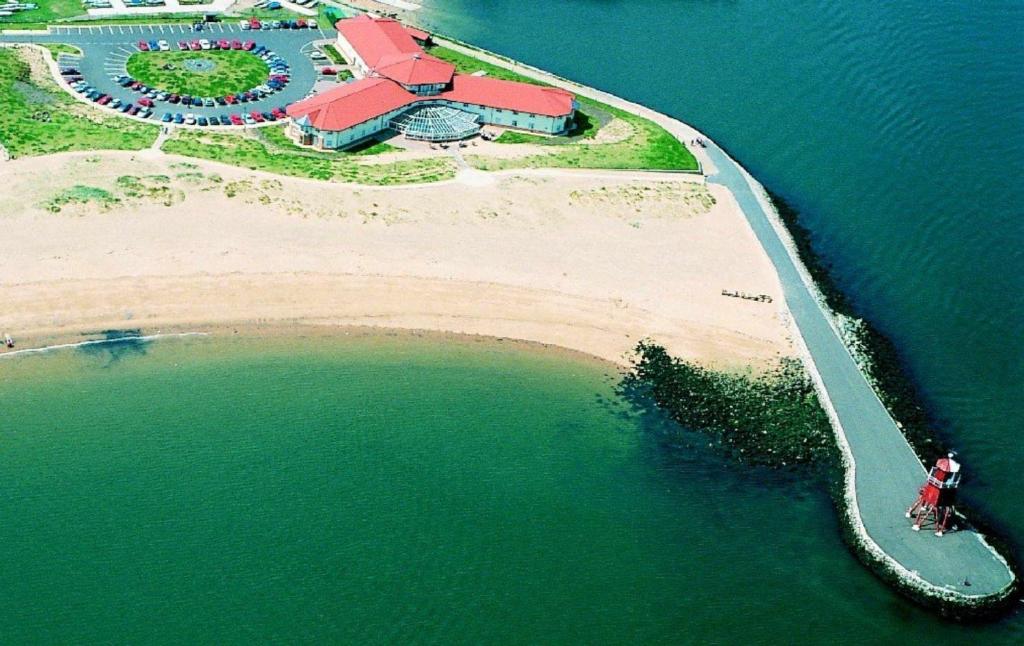 an aerial view of an island in the water at The Little Haven Hotel in South Shields