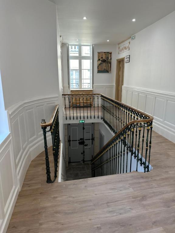 a hallway with a spiral staircase in a house at Studio familial du Cloitre in Narbonne