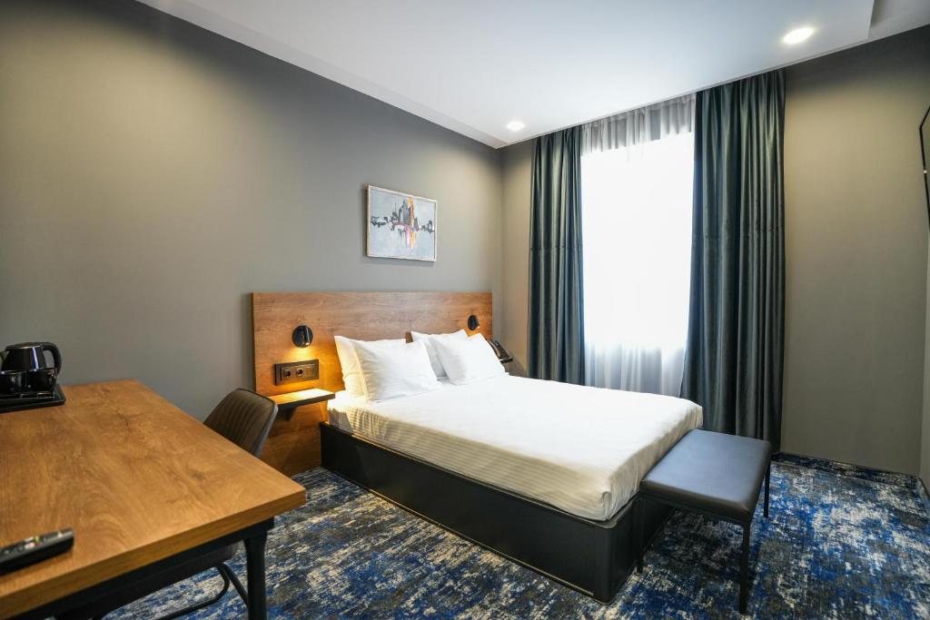 Postel nebo postele na pokoji v ubytování Hotel Splendid Tbilisi