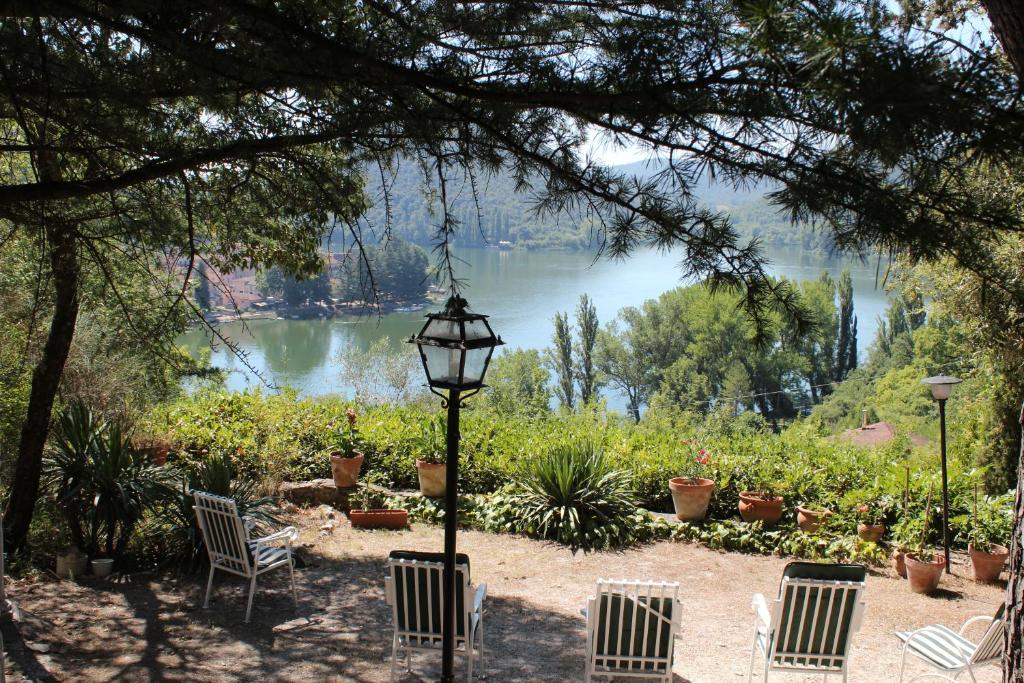 a group of chairs and a street light next to a lake at Villa Orio Lake Piediluco in Piediluco