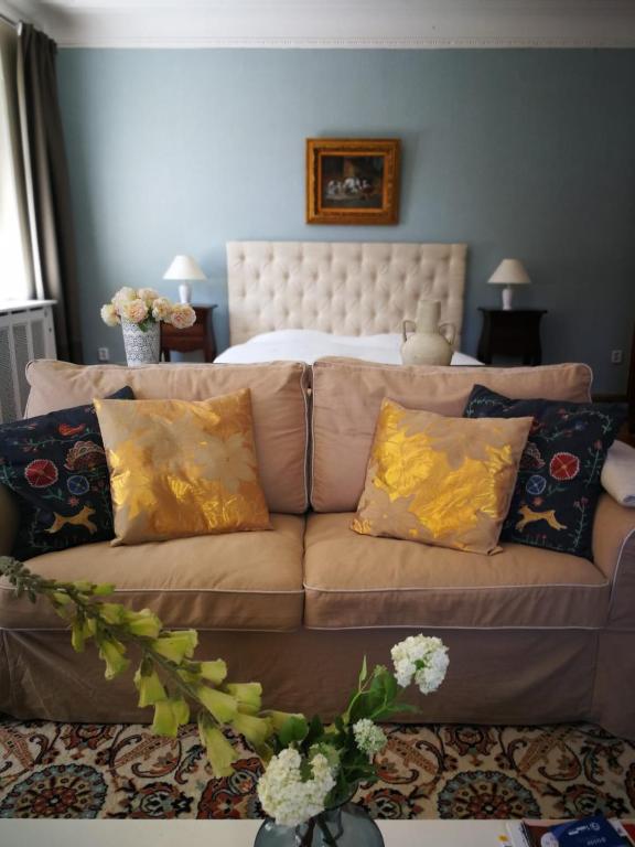 a living room with a couch and a bed at Vila Adelaide in Brtníky