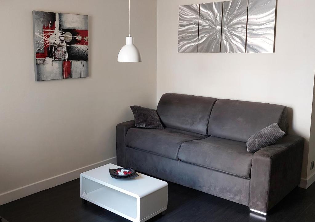 a living room with a couch and a table at Cannes Riviera in Cannes