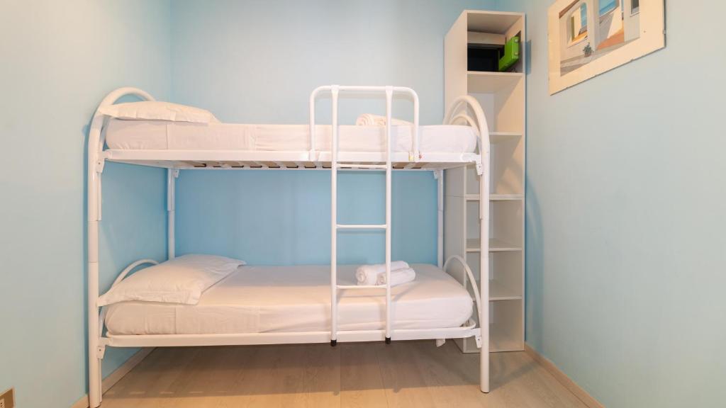 Łóżko lub łóżka w pokoju w obiekcie Sardinianworld-Appartamento Azzurro