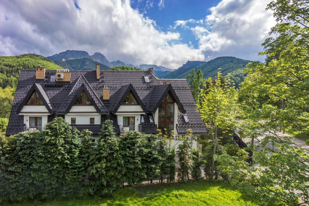 a house in the mountains with a fence at Willa Halka in Zakopane