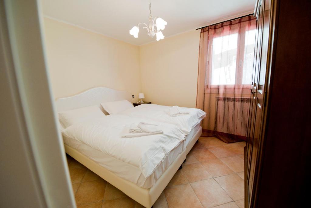 Postel nebo postele na pokoji v ubytování Residence La Corte