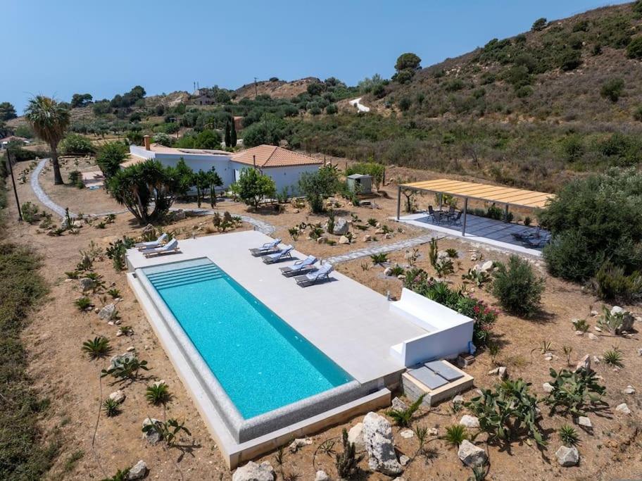 an aerial view of a swimming pool in a resort at Villa Aionia in Lepeda in Lixouri