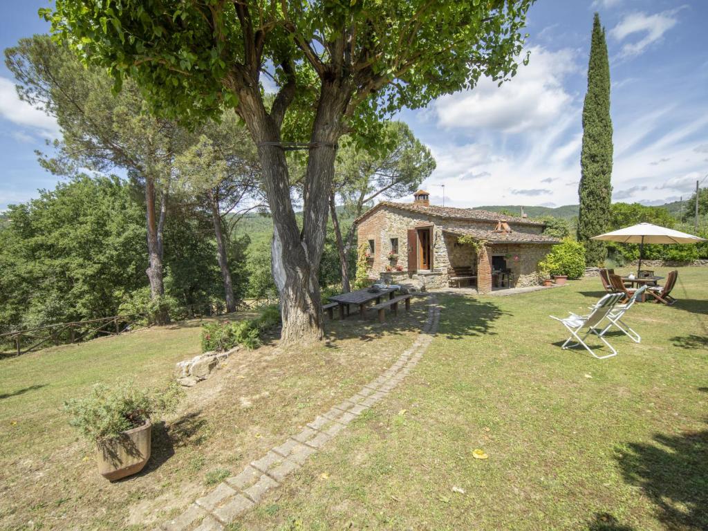 an external view of a house with a tree and a table and chairs at Holiday Home Il Lamone by Interhome in Ambra