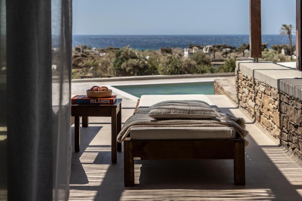 a bedroom with a bed and a swimming pool at Ela Tinos in Arnados
