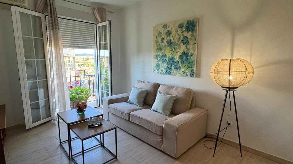 a living room with a couch and a table at PUEBLO ENCANTO, Apartamento Rural in Herrera del Duque