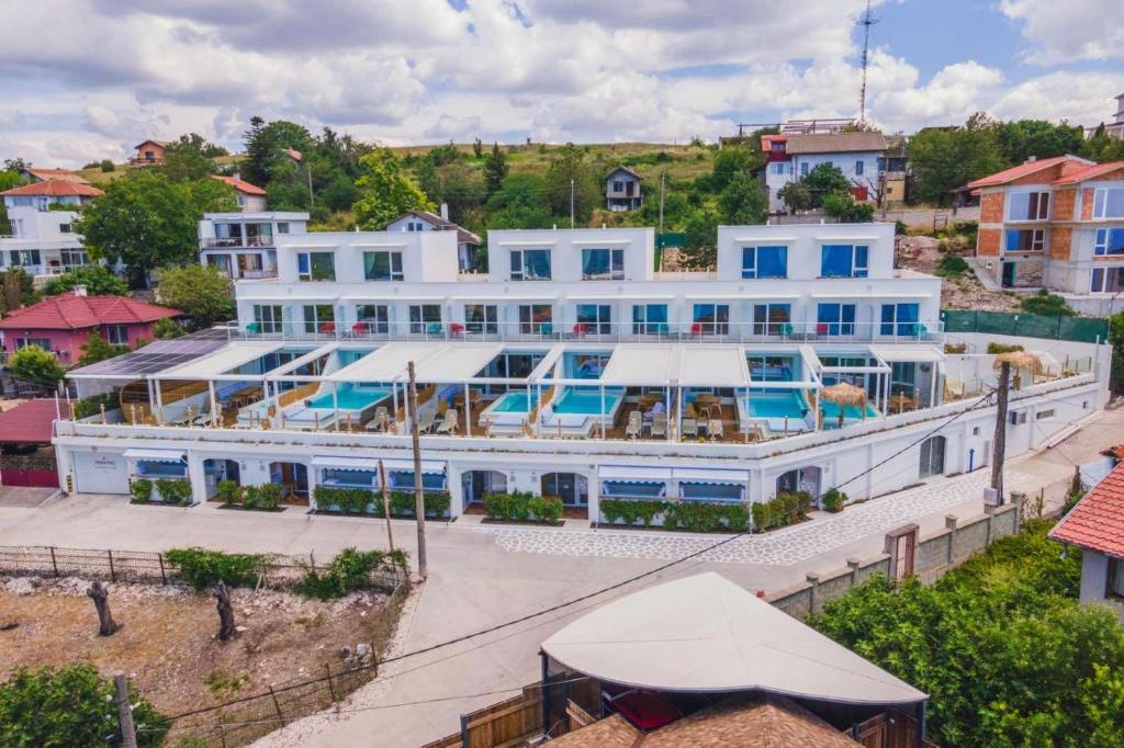 a large white building with a swimming pool at Villa Kalimera in Balchik