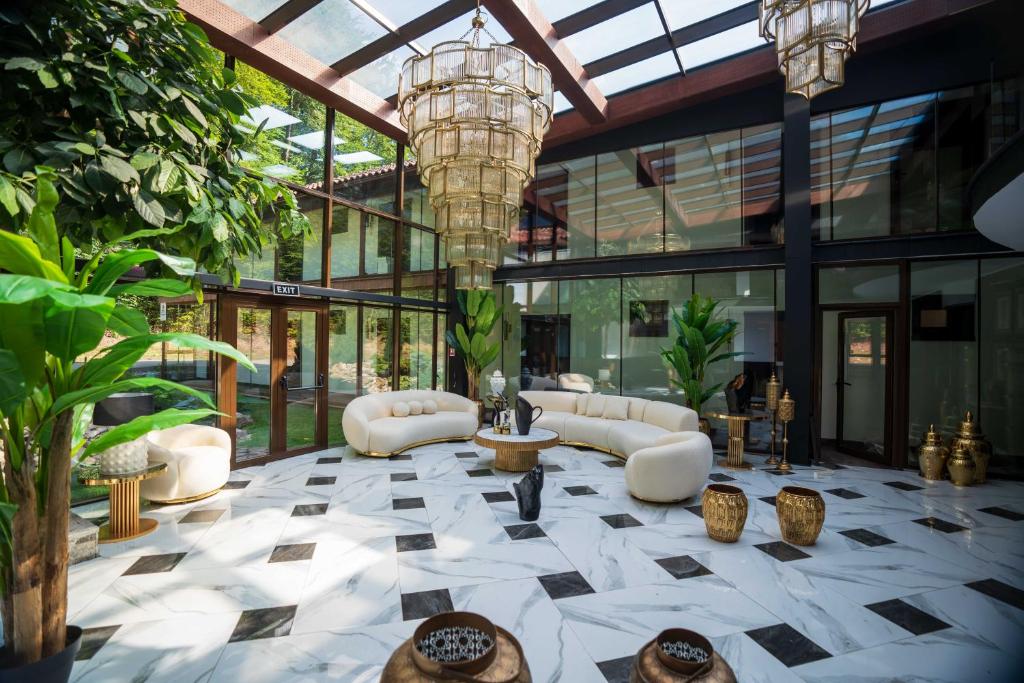 a lobby with a large glass building with a chandelier at Marabou Resort in Braşov