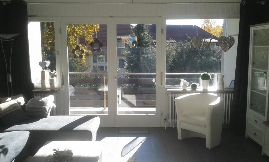 a living room with a bed and a sliding glass door at Ferienwohnung Steffens Hahnenklee in Hahnenklee-Bockswiese