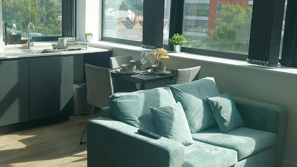 a living room with a couch and a table at Stunning one bedroom near Old Trafford Stadium in Manchester