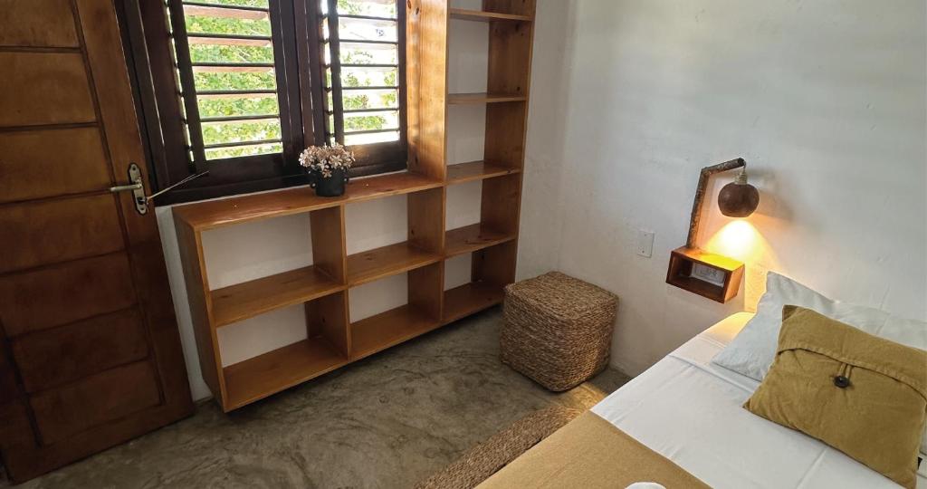 a bedroom with a bed and a window and a windowpect at Mandala Hostel Jeri in Jericoacoara