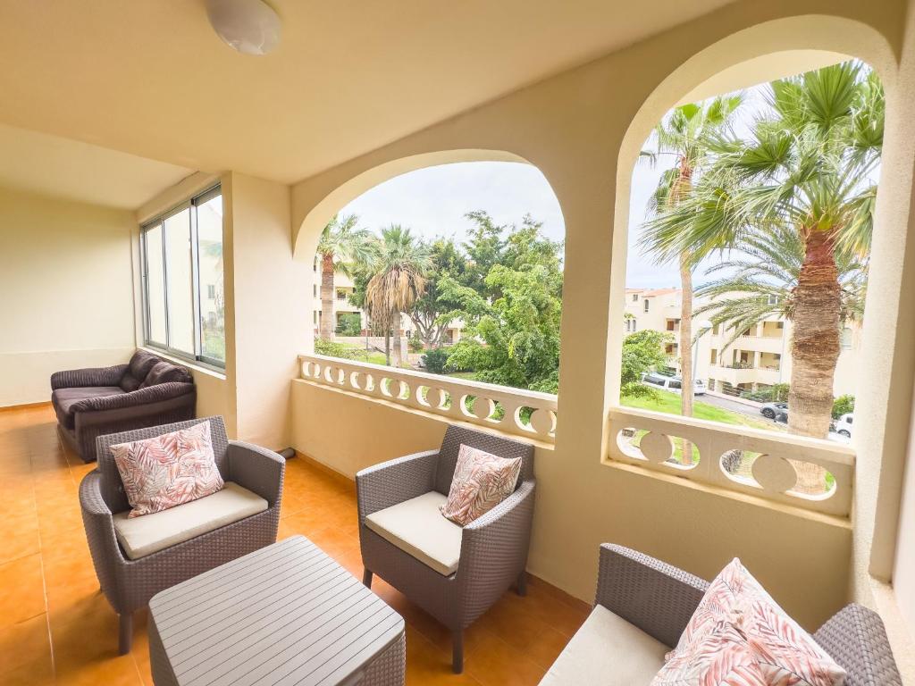 a waiting room with chairs and tables and windows at Sunny Ocean View Terrace 3BR Retreat by the Ocean Costa Adeje in Callao Salvaje