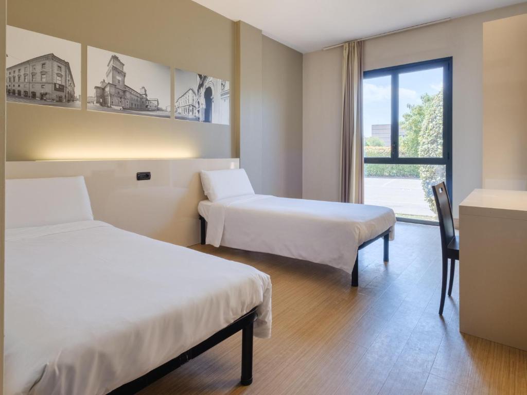 Postel nebo postele na pokoji v ubytování B&B Hotel Ferrara