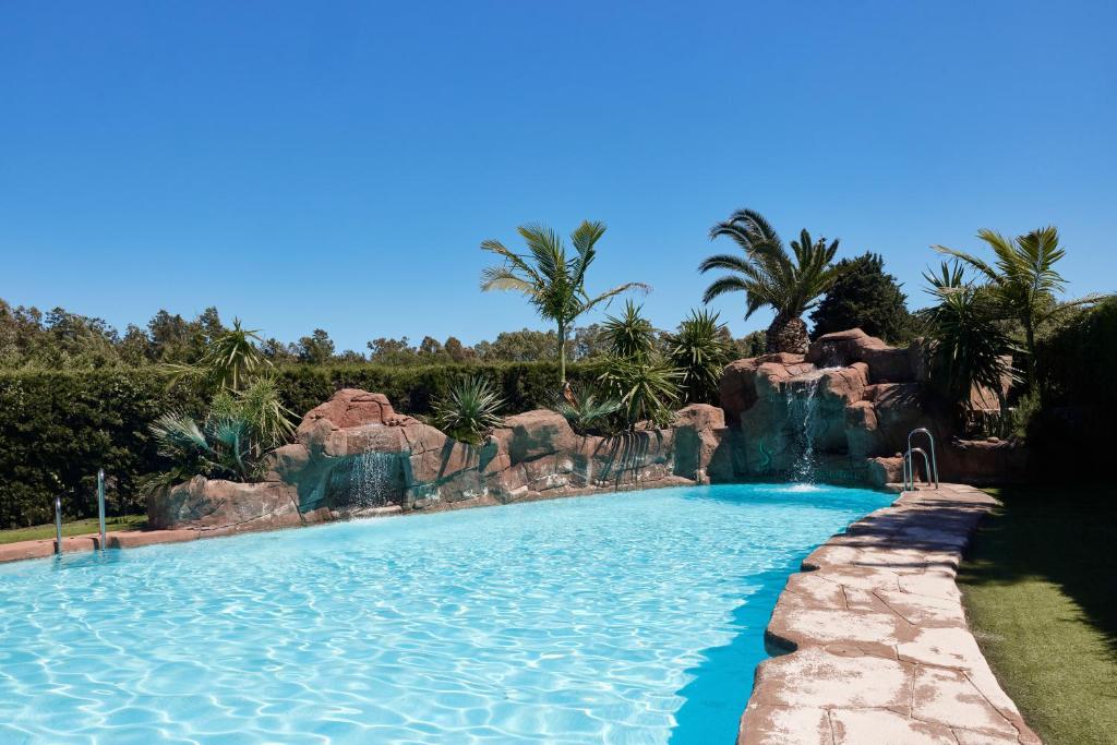 a pool at a resort with a water slide at TAIGA Tarifa Punta Paloma in Tarifa