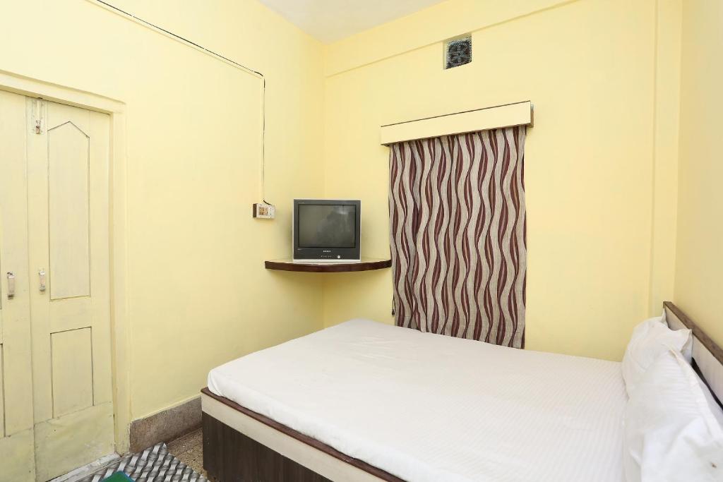 Postel nebo postele na pokoji v ubytování Hotel O Surya