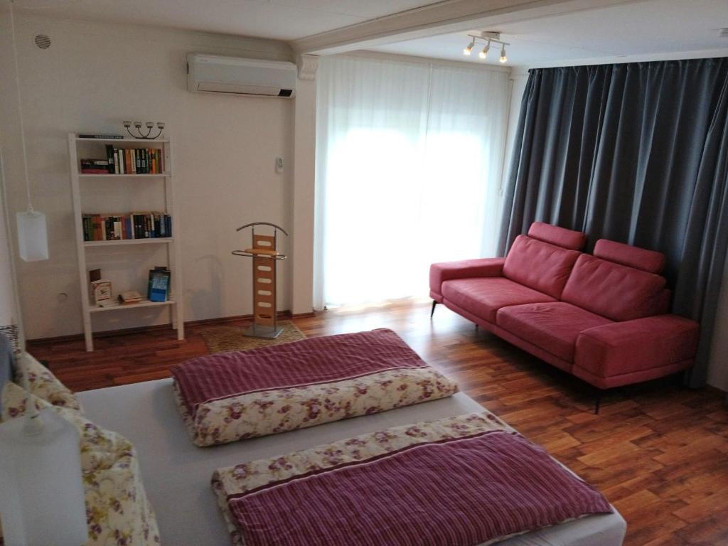 a living room with a couch and a red sofa at Auszeit 39 in Stadtoldendorf