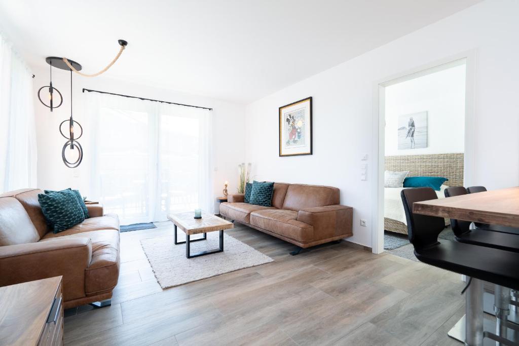 a living room with a couch and a table at Paddel Nr 5 in Neustadt in Holstein