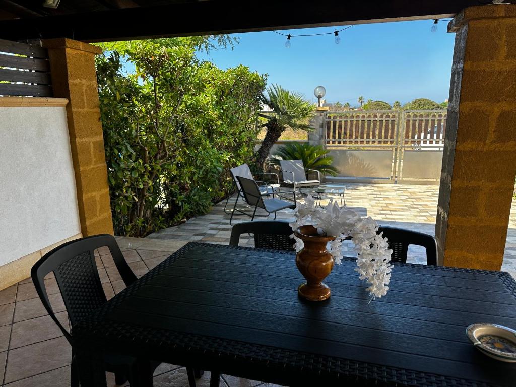 a black table with a vase on a patio at Panorama in Lido Signorino