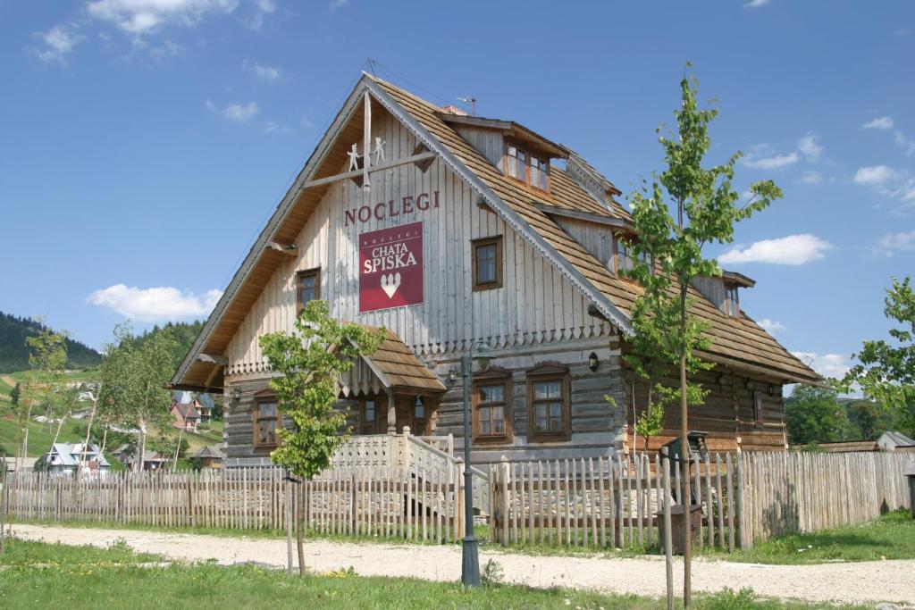 a wooden house with a fence in front of it at Polana Sosny in Niedzica Zamek