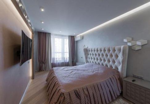 En eller flere senge i et værelse på Квартира