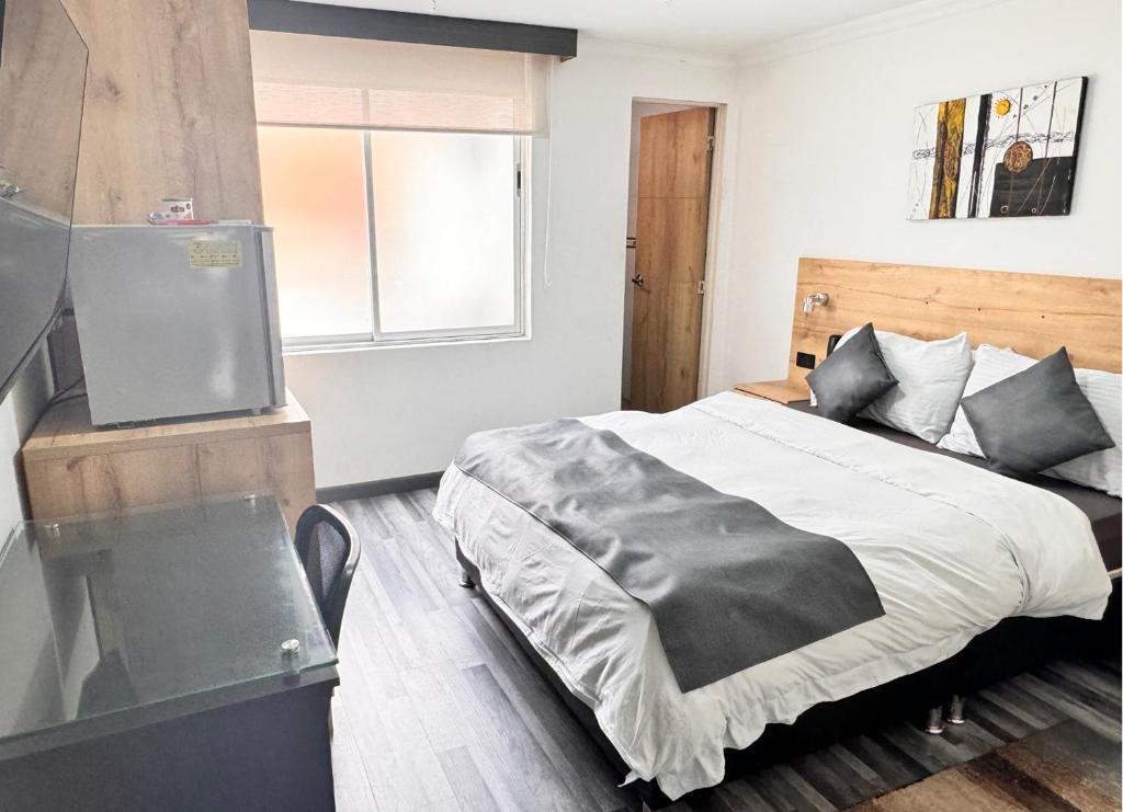 Postel nebo postele na pokoji v ubytování Hotel Fénix Real Bogotá