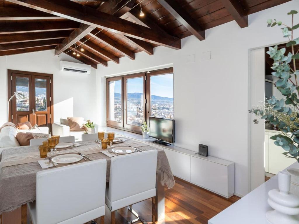 a living room with white furniture and large windows at Lovely House in Granada's Eye in Granada