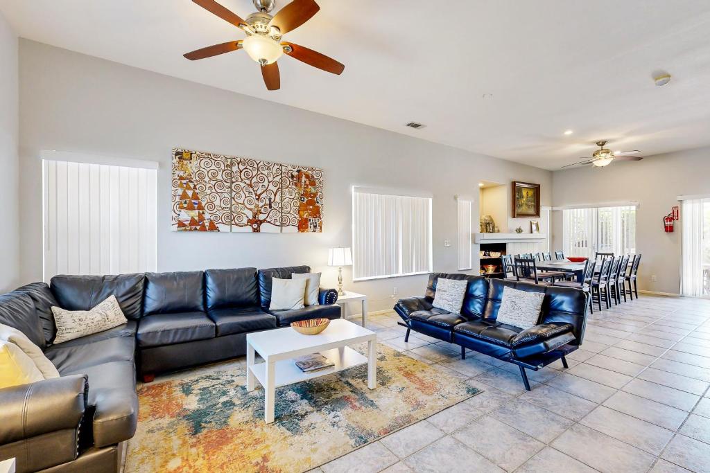 a living room with a couch and a table at Sawgrass Summer in Cathedral City