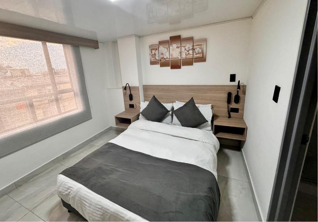 Postel nebo postele na pokoji v ubytování Hotel Fénix Real Bogotá