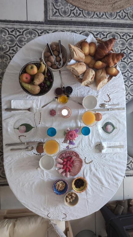 a white table with a bunch of food on it at La Petite Maison de Locarn in Locarn