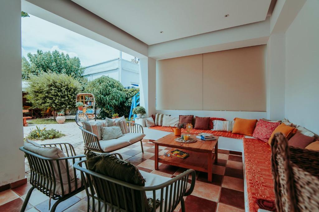 a living room with a couch and chairs at Saronis Hotel Agistri - Adults Only in Skala