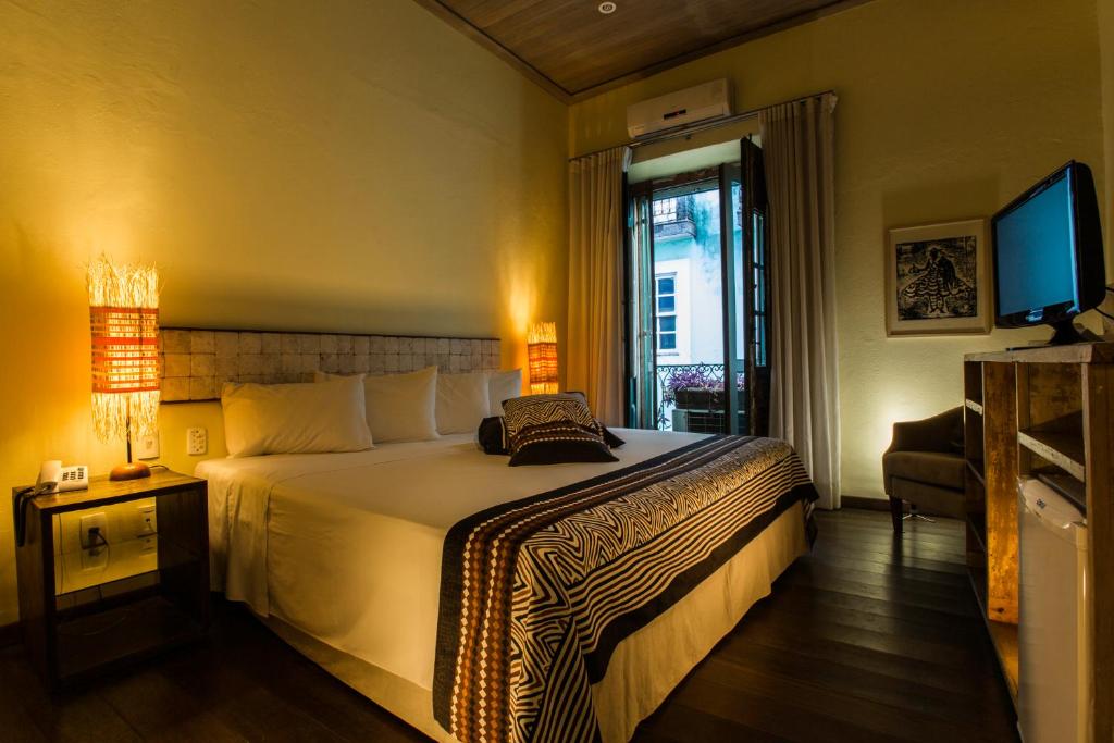 Postel nebo postele na pokoji v ubytování Bahiacafé Hotel