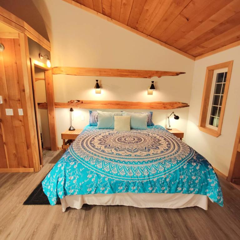 a bedroom with a large bed in a room at Hummingbird B&B in Gabriola